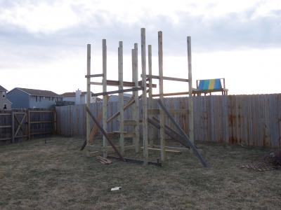 Playset walls tacked in place in the yard